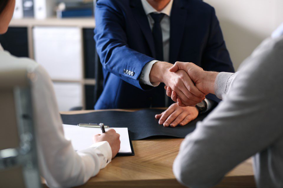 Lawyer shaking hands with clients